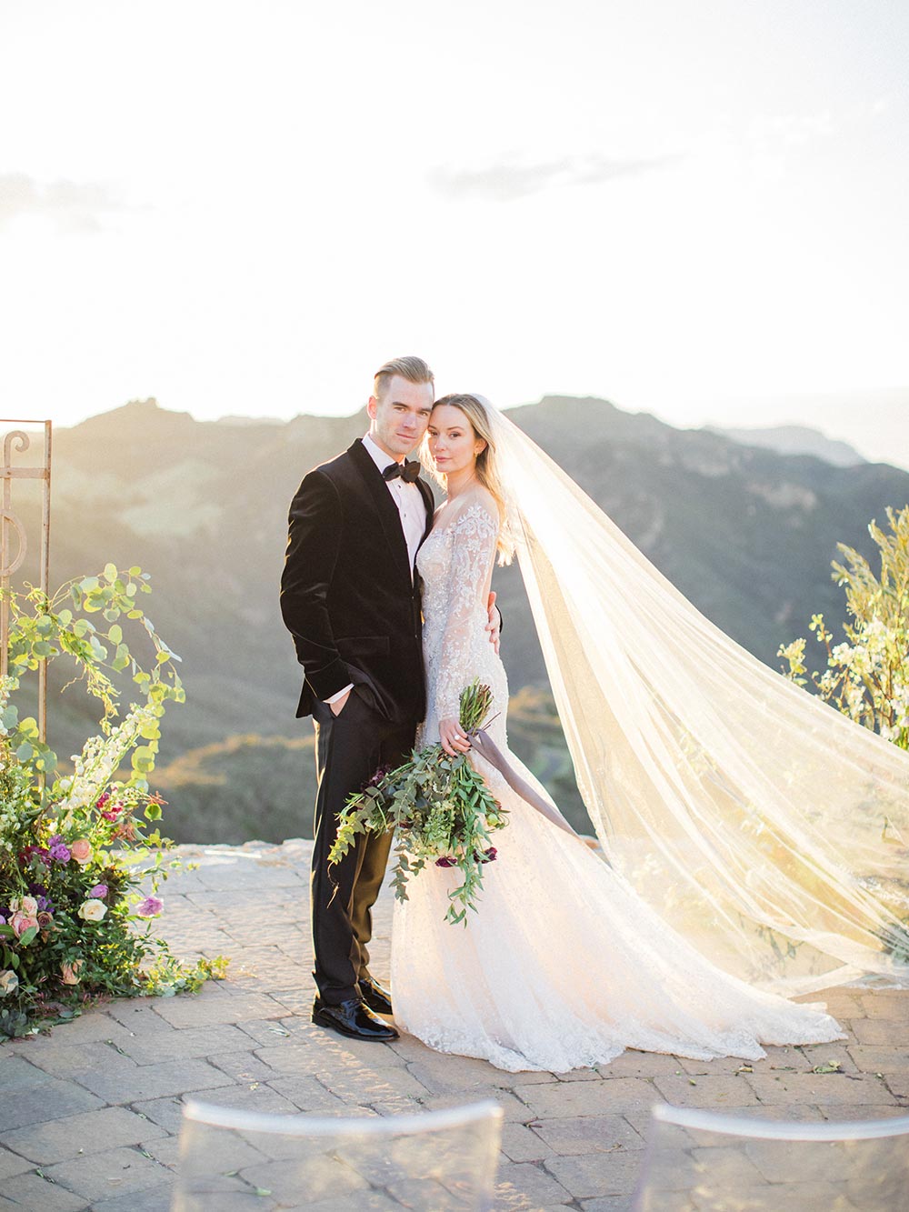 long sleeve embellished wedding dress with veil and black velvet groom tux